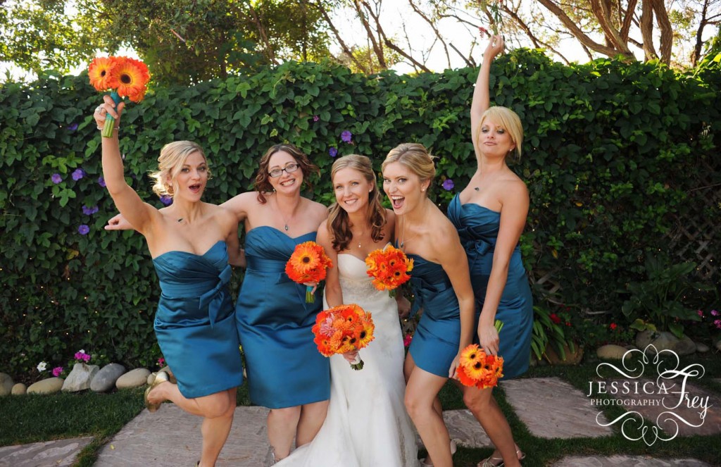 Short blue turquoise bridesmaid dresses with orange gerber daisy bouquets 