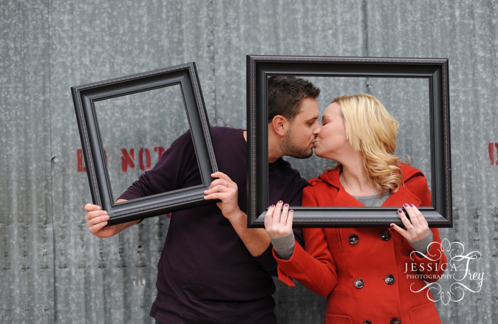 red and purple engagement outfits, picture frame engagement photo idea